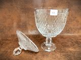 a glass cup and a spoon sitting on a table