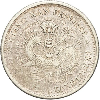a close up of a coin with a dragon on it