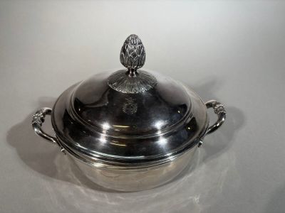 a large silver pot with a lid on a table