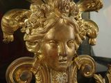 a gold statue of a woman with a crown on her head