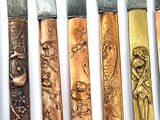 five different types of knives on a white surface
