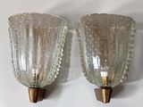 two glass vases that are on the wall