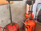 two fire extinguisors sitting next to each other in a room