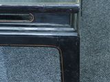 a small black table with a mirror on top of it