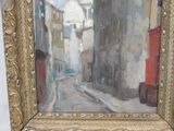 a painting of a street scene in a gold frame