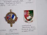 two pins on a piece of paper with a picture of a coat of arms and a cross