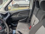 the interior of a small car with a steering wheel and seat covers
