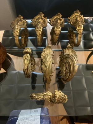 a glass table with a bunch of gold items on it