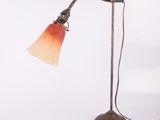 an image of a desk lamp with a red shade on it