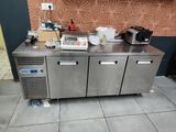 a stainless steel counter with a lot of items on top of it