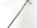 a close up of a sword with a wooden handle on a white surface