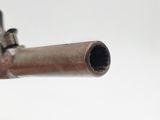 a close up of a gun on a white surface