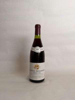 the bottle of wine is sitting on the table next to the glass