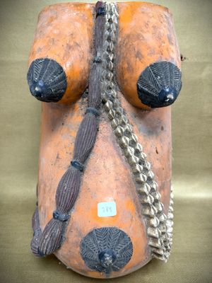 an image of a clay mask with a chain around it