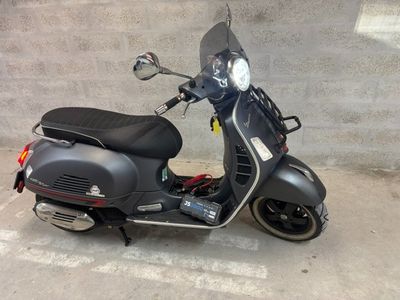 a scooter that is parked on the side of the street