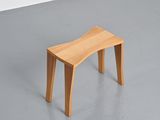 a small wooden bench sitting on the floor in a room