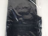a black shirt in a plastic bag on a table