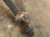 a close up of a pipe on a wooden floor