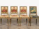 six chairs with floral upholstered seats are lined up against a white wall