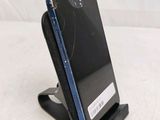 a cell phone that is on a stand on a table