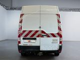 a white van with red and white stripes parked in a garage