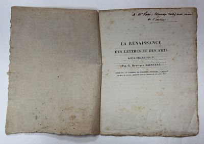 an old book opened to reveal a page of text on a white surface