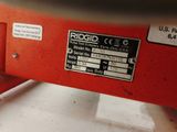 a close up of a red machine with a label on it