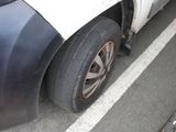 a car that has a flat tire on the side of the road