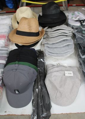 many hats that are on a table in a store