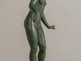 statue of a woman standing on a base with her hands on her hips
