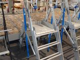 many ladders that are sitting in a room