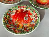 three plates with different designs on them sitting on a table