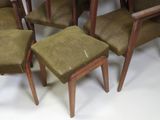 several brown chairs are lined up against a white background