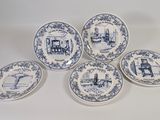 six blue and white plates with a picture of a man in a kitchen