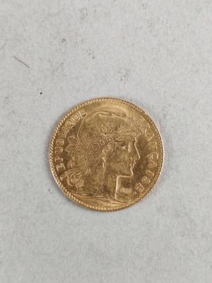 a close up of a gold coin on a white surface