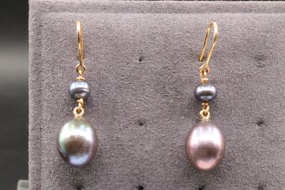 pair of multi colored pearl earrings on display in a display case