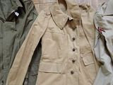 two jackets and a pair of shoes on a wooden floor