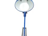 blue desk lamp on a white background with a cord plugged in