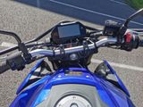 a close up of a motorcycle with a gps device on the handlebars