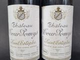 two bottles of wine sitting next to each other on a table