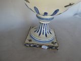 a blue and white vase sitting on top of a table