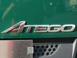 a close up of a green truck with a logo on it