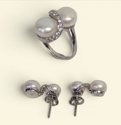 three pieces of jewelry including a ring, earring and a pair of earrings