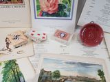 many cards, stamps, and a clock on a table