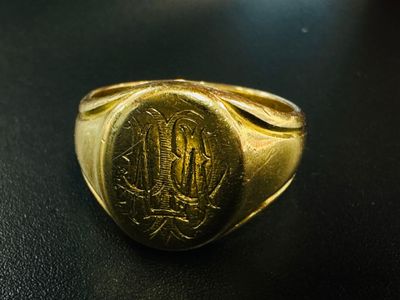 an image of a gold signet ring with a monogram on it