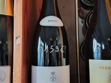 three bottles of wine in a wooden box on a shelf