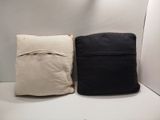 two pillows that are sitting on a white shelf