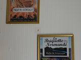 two pictures on the wall above a table with a cake on it