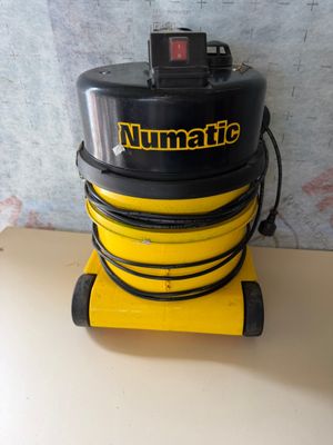 a close up of a yellow and black vacuum on a table