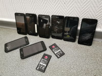 a lot of cell phones that are sitting on the floor